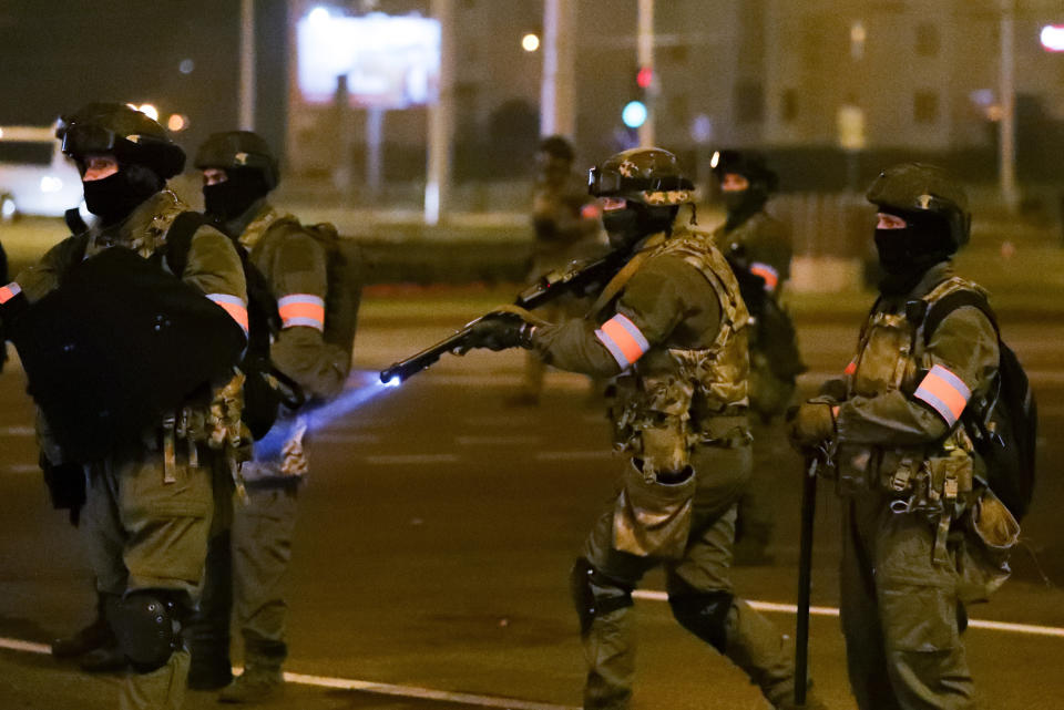 A policeman prepares to aim his weapon during a mass protest following presidential elections in Minsk, Belarus, Monday, Aug. 10, 2020. Thousands of people have protested in Belarus for a second straight night after official results from weekend elections gave an overwhelming victory to authoritarian President Alexander Lukashenko, extending his 26-year rule. A heavy police contingent blocked central squares and avenues, moving quickly to disperse protesters and detained dozens. (AP Photo/Sergei Grits)