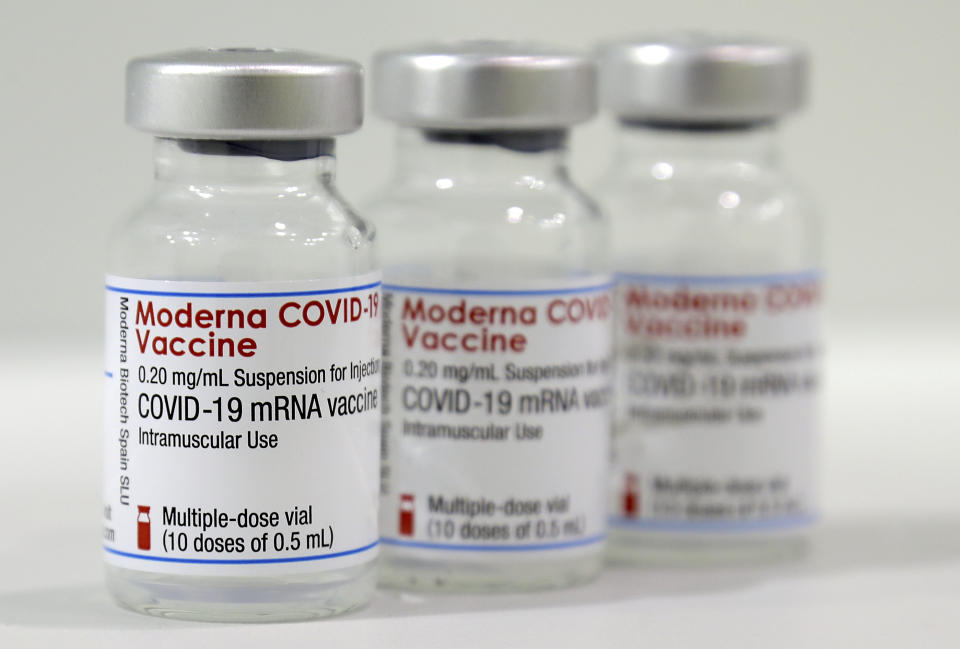 Three vials of the 'Moderna COVID-19 Vaccine' are pictured in a new coronavirus, COVID-19, vaccination center at the 'Velodrom' (velodrome-stadium) in Berlin, Germany, Wednesday, Feb. 17, 2021. (AP Photo/Michael Sohn, pool)