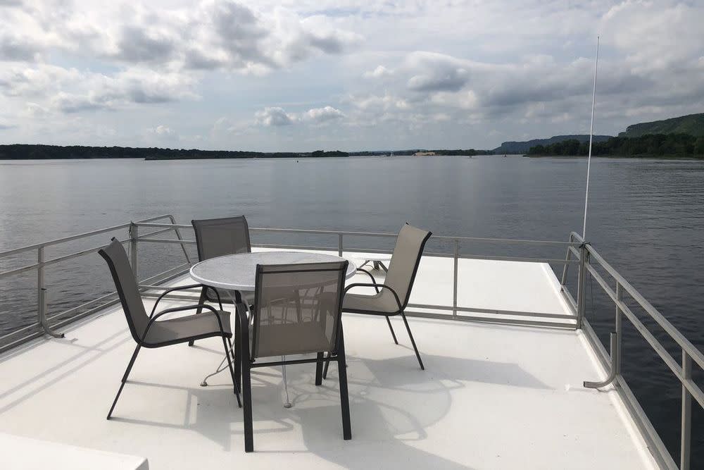 view of Upper Mississippi River in Alma, Wisconsin from houseboat, chairs