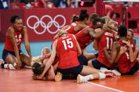 <p>USA's players celebrate their victory in the women's gold medal volleyball match between Brazil and USA during the Tokyo 2020 Olympic Games at Ariake Arena in Tokyo on August 8, 2021. (Photo by Yuri Cortez / AFP) </p> 