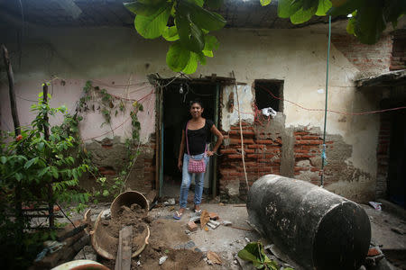 Peregrina, 26, an indigenous Zapotec transgender woman also know as Muxe, poses for a photo outside of her house destroyed after an earthquake that struck on the southern coast of Mexico late on Thursday, in Juchitan, Mexico, September 10, 2017. REUTERS/Edgard Garrido