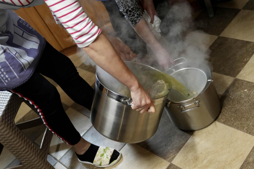 Members of a Muslim congregation cook soup for migrants at the Polish-Belarusian border in Bohoniki near Sokolka, Poland, Saturday, Nov. 13, 2021. (AP Photo/Matthias Schrader)