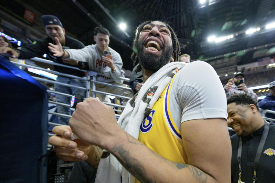 Los Angeles Lakers forward Anthony Davis (3) laughs after talking to his father, Anthony Davis, Sr., after defeating the New Orleans Pelicans in an NBA basketball game in New Orleans, Tuesday, March 14, 2023. (AP Photo/Matthew Hinton)