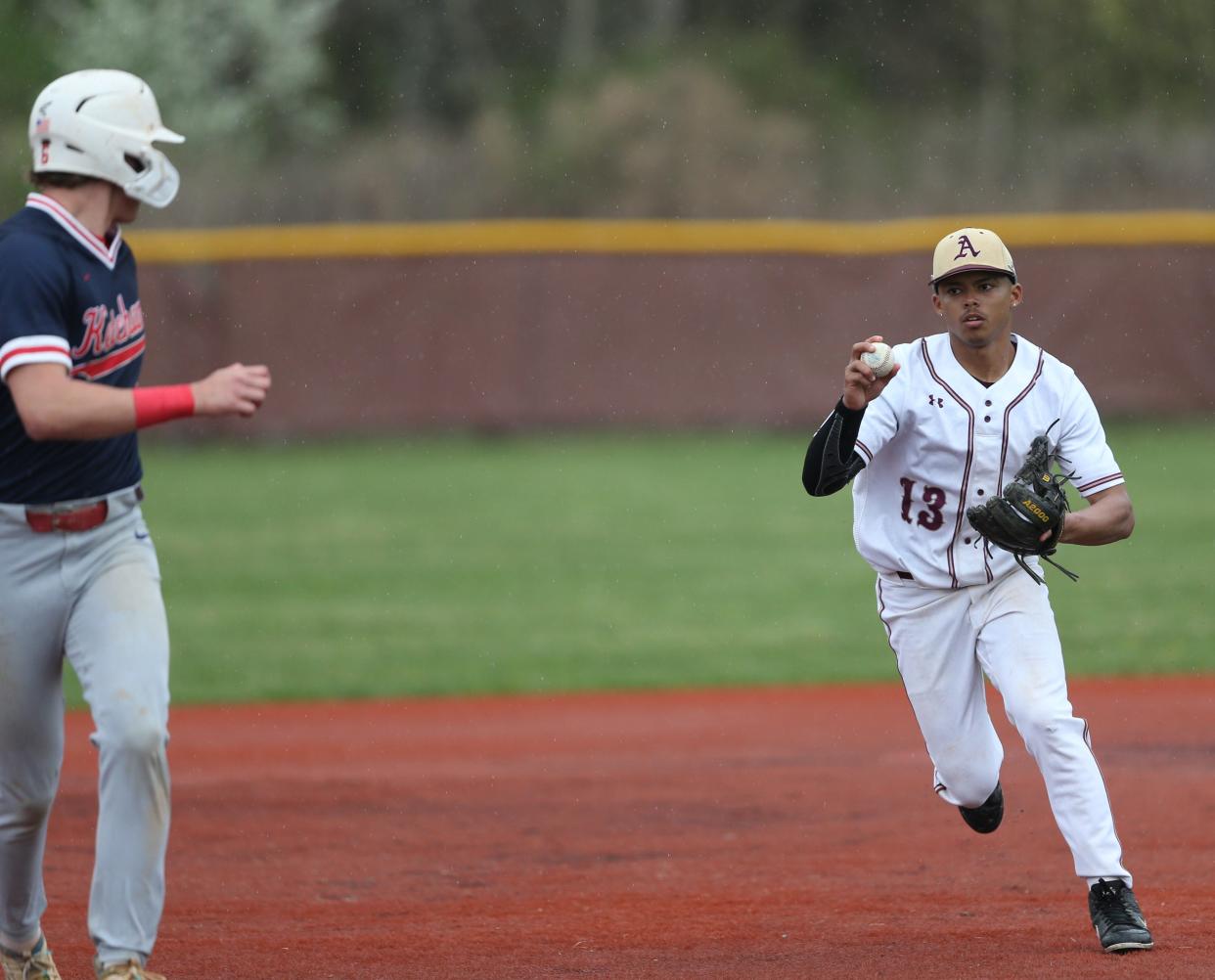 Arlington's Eric Santaella runs down Roy C. Ketcham's Owen Paino during a game on April 17, 2024.