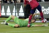 Los Angeles FC goalkeeper Tomas Romero, bottom, stops a shot from Dallas FC defender Justin Che during the first half of an MLS soccer match Wednesday, June 23, 2021, in Los Angeles. (AP Photo/Marcio Jose Sanchez)