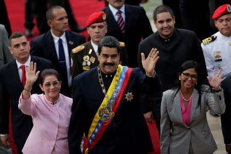 Venezuela's President Nicolas Maduro (C), his wife Cilia Flores (front L) and National Constituent Assembly President Delcy Rodriguez (front R), wave as they arrive for a session of the assembly at Palacio Federal Legislativo in Caracas, Venezuela August 10, 2017. REUTERS/Ueslei Marcelino