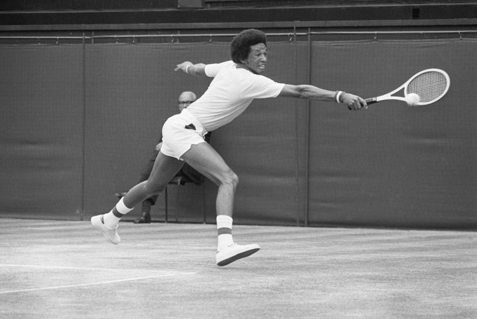 <p>Arthur Ashe hits a backhand return to Jimmy Connors during their men's singles title match at Wimbledon. Ashe won 6-1, 6-1, 5-7, 6-4 in 1975.</p>