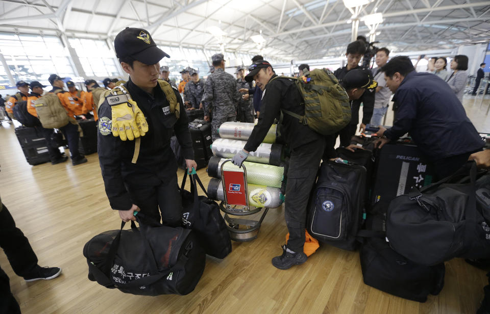 South Korean rescue team members prepare to board a plane to leave for Budapest at Incheon International Airport in Incheon, South Korea, Thursday, May 30, 2019. A massive search is underway on the Danube River in downtown Budapest for over a dozen people missing after a sightseeing boat with 33 South Korean tourists sank after colliding with another vessel during an evening downpour. (AP Photo/Ahn Young-joon)