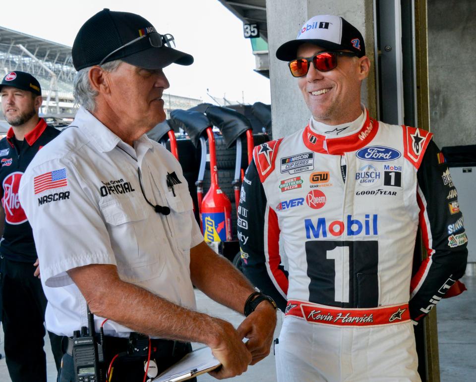 NASCAR Cup Series driver Kevin Harvick (4) talks with NASCAR official David Green on Saturday, Aug. 12, 2023, during practice for the NASCAR Cup Series Verizon 200 at Indianapolis Motor Speedway.