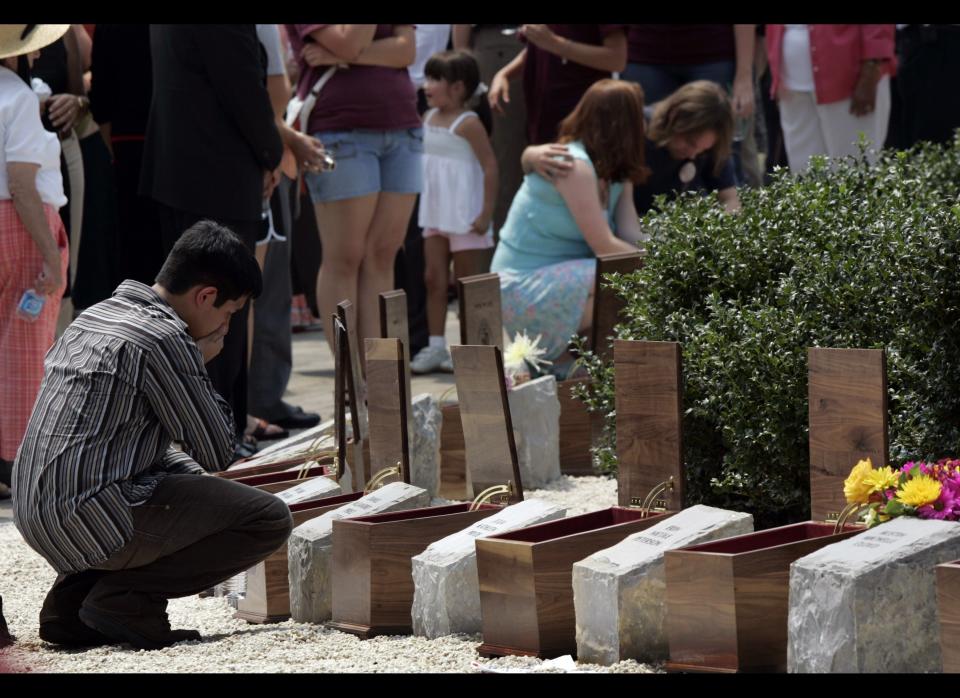 An unidentified family member of slain Virginia Tech student Daniel Alejandro Prez Cueva, pauses at his memorial stone after the dedication of the memorial for the victims of the Virginia Tech shooting in Blacksburg, Va., Sunday, Aug. 19, 2007. More than 10,000 people gathered on the main campus lawn as Virginia Tech dedicated 32 memorial stones for those killed by a student in a mass shooting on campus last April.