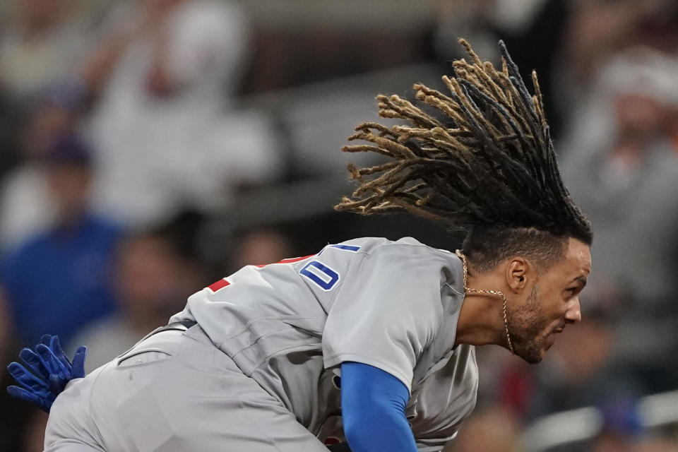 Chicago Cubs' Michael Hermosillo (32) dives into first base before being tagged out by Atlanta Braves first baseman Matt Olson (28) in the eighth inning of a baseball game, Tuesday, April 26, 2022, in Atlanta. (AP Photo/Brynn Anderson)