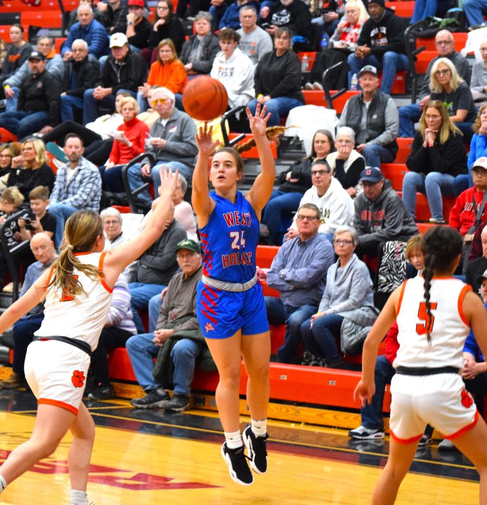 Keegan Uhl launches a 3-pointer over the Strasburg defense Monday in the Classic in the Country at Hiland. Uhl hit four 3-pointers to help West Holmes to a 53-32 victory.