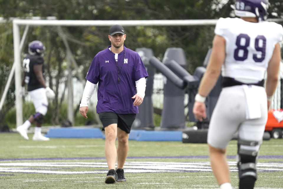 Northwestern interim head coach David Braun, center, walks on the field as he watches players during team's practice in Evanston, Ill., Wednesday, Aug. 9, 2023. (AP Photo/Nam Y. Huh)