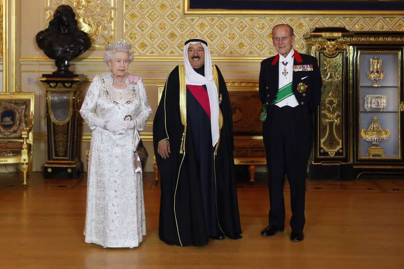 FILE PHOTO: Britain's Queen Elizabeth poses for a photograph with the Emir of Kuwait, Sheikh Sabah al-Ahmad al-Sabah and her husband Prince Philip at Windsor Castle, in Windsor