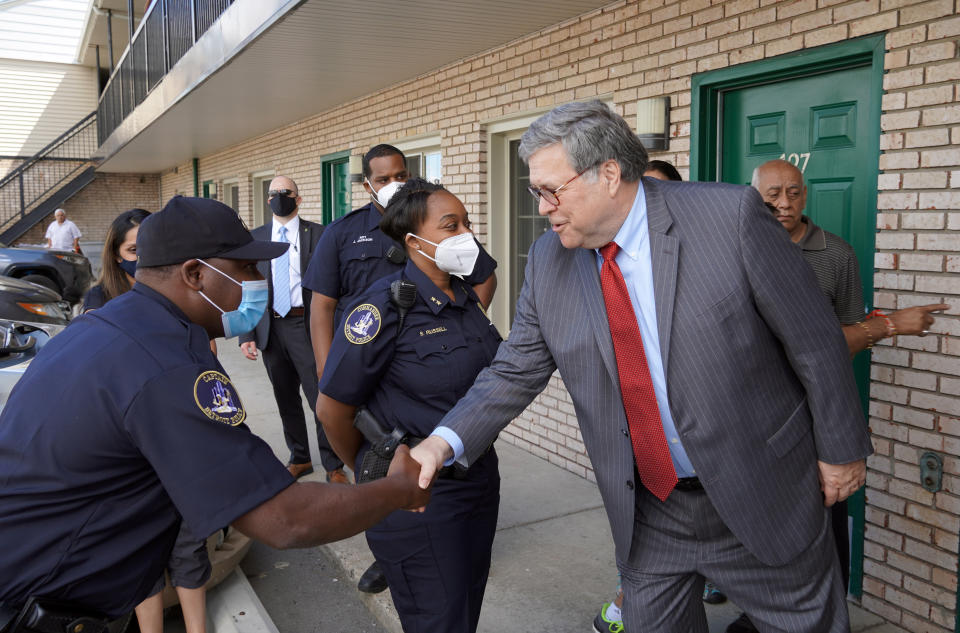 In this Aug. 18, 2020, photo Attorney General William Barr shakes hands with Detroit police officers outside the JZ Motel in Detroit. (AP Photo/Mike Balsamo)