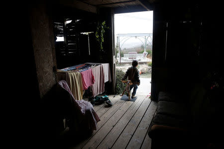 An Israeli boy from the Ziv family stands in the doorway of his home in the Jewish settler outpost of Amona in the West Bank, November 22, 2016. REUTERS/Ronen Zvulun