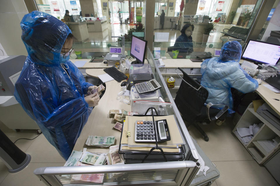 SHANXI, CHINA - FEBRUARY 24: (CHINA MAINLAND OUT)The bank workers sanitize the cash to kill the novel coronavirus on 24th February, 2020 in Taiyuan,Shanxi,China.(Photo by TPG/Getty Images)