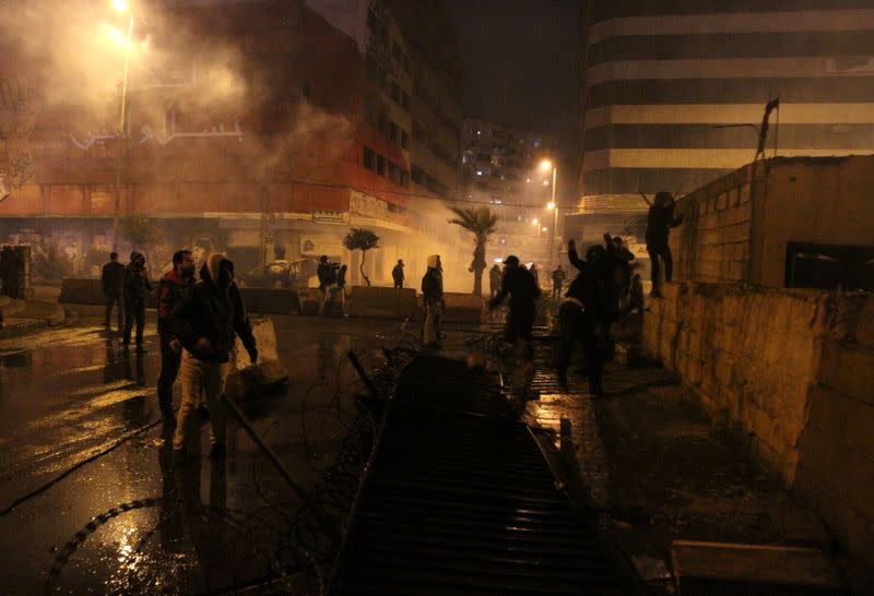 Demonstrators throw stones during a protest against the lockdown and worsening economic conditions, amid the spread of the coronavirus disease (COVID-19), in Tripoli