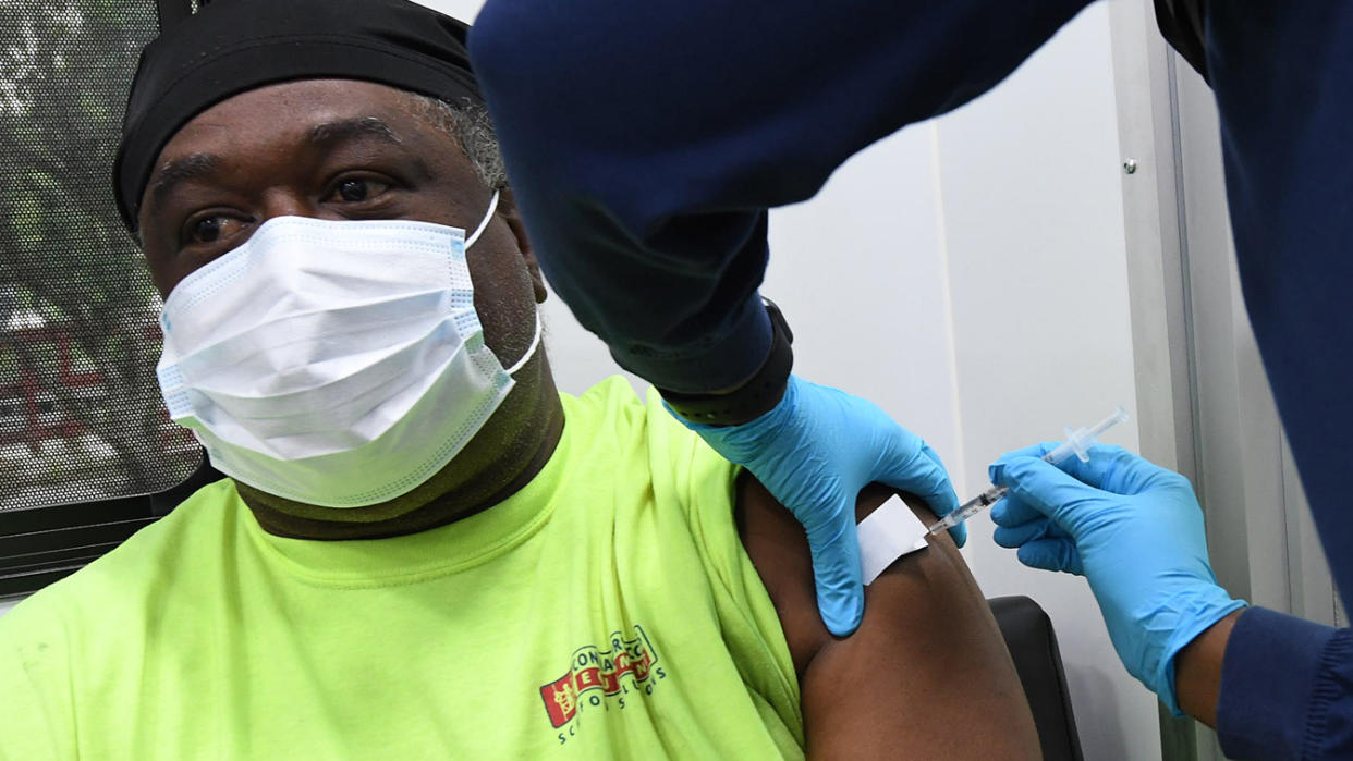 Howard Douglas receives a shot of the Pfizer vaccine at a mobile COVID-19 vaccination site. (Paul Hennessy/SOPA Images/LightRocket via Getty Images)
