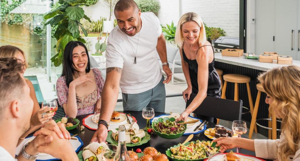 Group of friends eating food over table