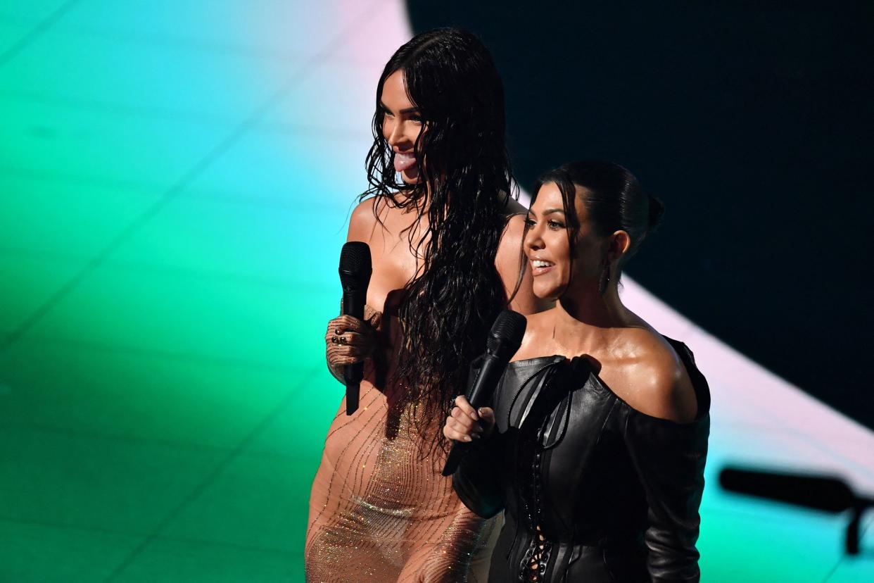 Megan Fox and Kourtney Kardashian speak onstage at the 2021 MTV Video Music Awards. (Photo: Angela Weiss/AFP via Getty Images)