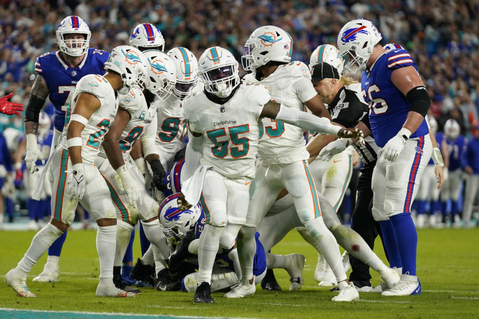 Miami Dolphins linebacker Jerome Baker (55) celebrates after tackling Buffalo Bills running back Ty Johnson (26) at the end of the first half of an NFL football game, Sunday, Jan. 7, 2024, in Miami Gardens, Fla. (AP Photo/Wilfredo Lee )