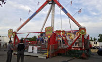 <p>Authorities stand near the Fire Ball amusement ride after the ride malfunctioned injuring several at the Ohio State Fair, Wednesday, July 26, 2017, in Columbus, Ohio. Some of the victims were thrown from the ride when it malfunctioned Wednesday night, said Columbus Battalion Chief Steve Martin. (Jim Woods/The Columbus Dispatch via AP) </p>