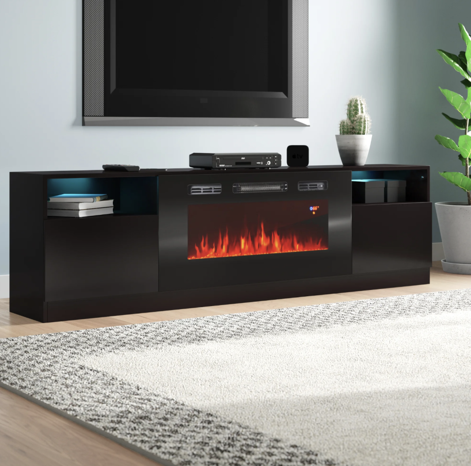 <p><a href="https://go.redirectingat.com?id=74968X1596630&url=https%3A%2F%2Fwww.wayfair.com%2F--%2Fpdp%2Forren-ellis--delaine-tv-stand-for-tvs-up-to-90-with-electric-fireplace-included-x115793541-l6-w004682430.html&sref=https%3A%2F%2Fwww.popularmechanics.com%2Fhome%2Fg37621995%2Fbest-fireplace-tv-stands%2F" rel="nofollow noopener" target="_blank" data-ylk="slk:Shop Now;elm:context_link;itc:0;sec:content-canvas" class="link ">Shop Now</a></p><p>Delaine Fireplace TV Stand</p><p>wayfair.com</p><p>$489.99</p>