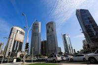 FILE PHOTO: Vehicles are seen in a traffic jam in front of government buildings next to skyscrapers in Doha