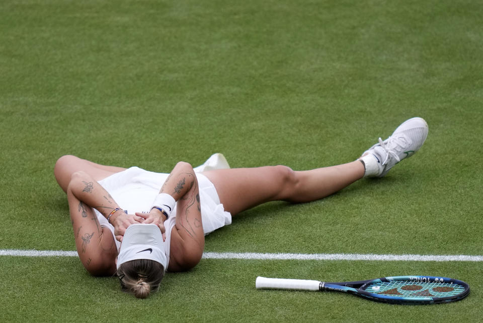Czech Republic's Marketa Vondrousova lays on the court as she reacts after beating Tunisia's Ons Jabeur to win the final of the women's singles on day thirteen of the Wimbledon tennis championships in London, Saturday, July 15, 2023. (AP Photo/Kirsty Wigglesworth)