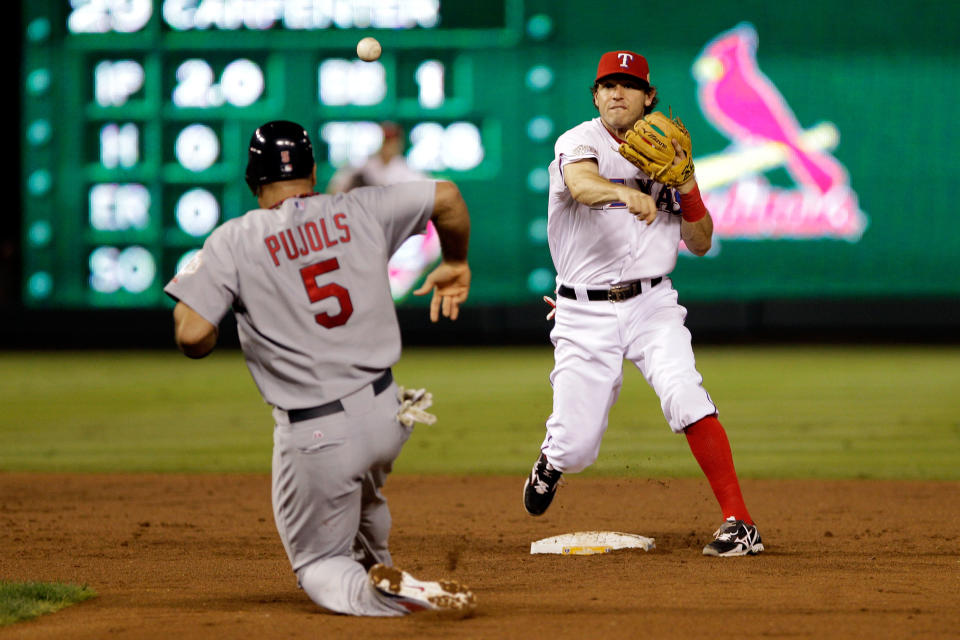 ARLINGTON, TX - OCTOBER 24: Ian Kinsler #5 of the Texas Rangers turns the double play as Albert Pujols #5 of the St. Louis Cardinals slides into second base in the third inning during Game Five of the MLB World Series at Rangers Ballpark in Arlington on October 24, 2011 in Arlington, Texas. (Photo by Rob Carr/Getty Images)