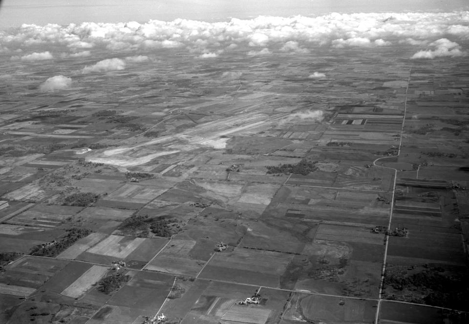 The site of Richard Bong Air Force Base, as seen from the air in November 1958. At the center is a 2-mile runway still under construction. More than 70 farms were bought by the federal government for the 5,400-acre base, mostly in Kenosha County. At the time this photograph was taken, the base was expected to be completed by the end of 1961, and be home for eight heavy bombers, 45 medium bombers, 25 fighter-interceptors and 20 flying tanker escorts.