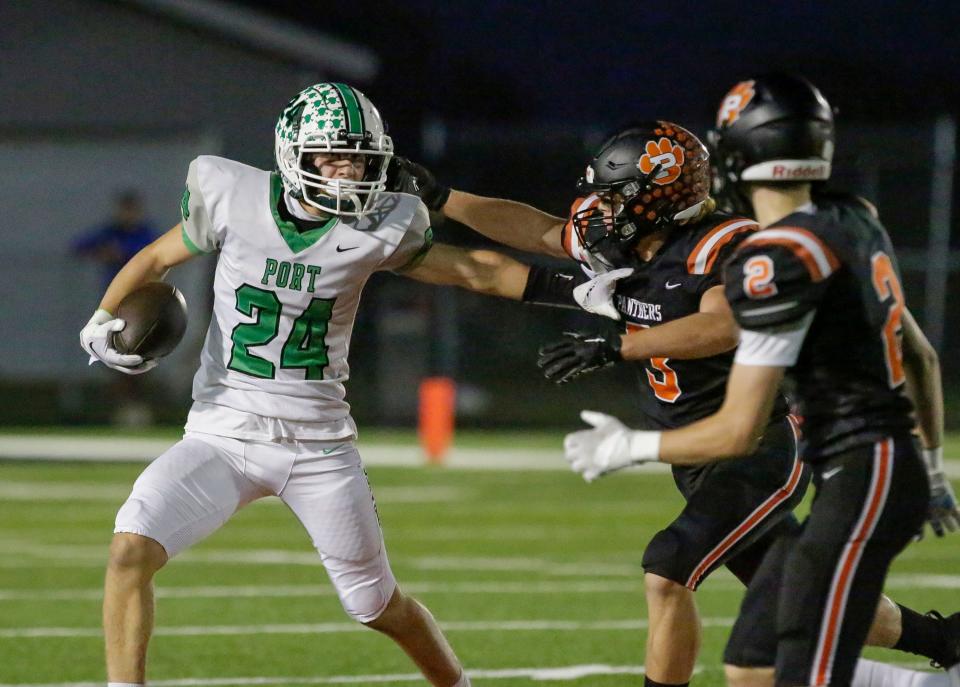 Port Washington’s Sam Pasten (24) works to evade Plymouth’s Brett Shutter (3) and Tom Blad (2) on Friday in Plymouth.