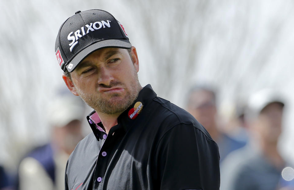 Graeme McDowell, of Northern Ireland, reacts to a missed putt on the seventh hole in his match against Hunter Mahan during the third round of the Match Play Championship golf tournament on Friday, Feb. 21, 2014, in Marana, Ariz. (AP Photo/Matt York)