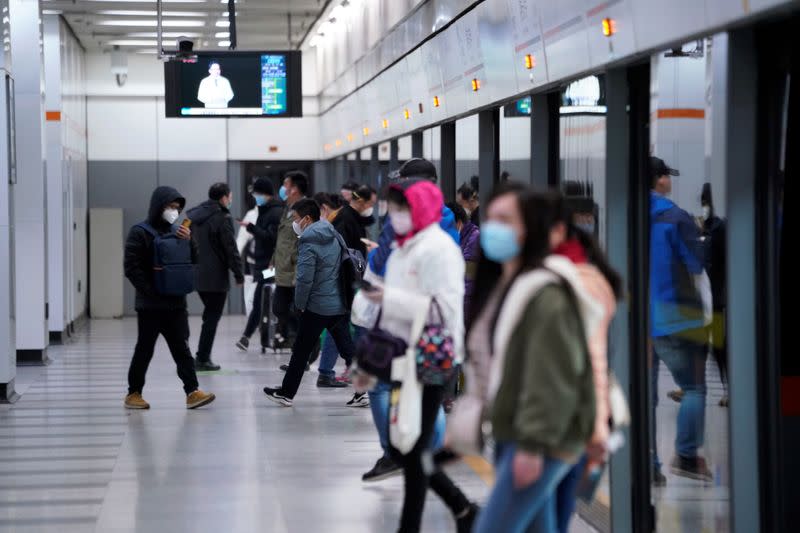 People wearing face masks are seen at a subway station in the morning after the extended Lunar New Year holiday caused by the novel coronavirus outbreak, in Shanghai