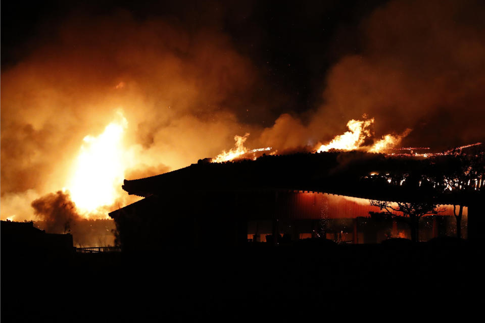 Smoke and flames rise from burning Shuri Castle in Naha, Okinawa, southern Japan, Thursday, Oct. 31, 2019. A fire early Thursday burned down structures at Shuri Castle on Japan's southern island of Okinawa, nearly destroying the UNESCO World Heritage site. (Jun Hirata/Kyodo News via AP)