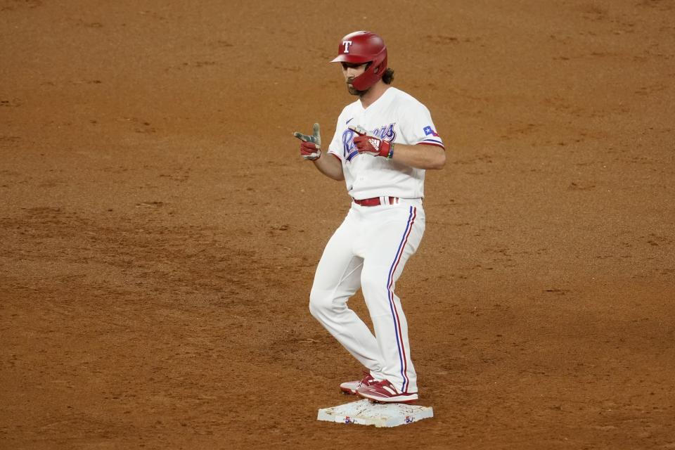 Texas Rangers' Charlie Culberson stands on second after a double during the second inning of the team's baseball game against the Seattle Mariners, Thursday, July 14, 2022, in Arlington, Texas. (AP Photo/Tony Gutierrez)