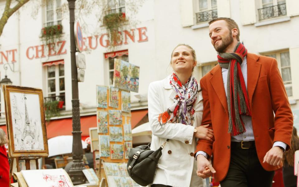 Couple walks the streets of Paris - Getty Images