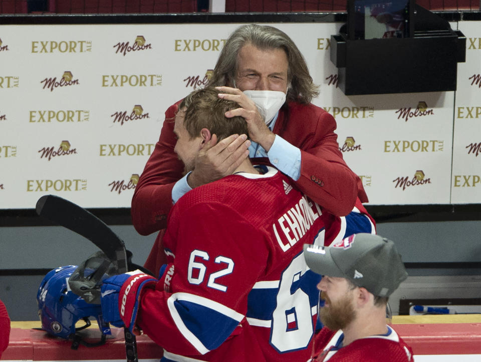 Montreal Canadiens left wing Artturi Lehkonen (62) gets a hug from general manager Marc Bergevin after scoring the winning goal to defeat the Vegas Golden Knights following overtime in Game 6 of an NHL hockey Stanley Cup semifinal playoff series Thursday, June 24, 2021 in Montreal. (Ryan Remiorz/The Canadian Press via AP)