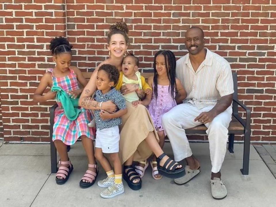 Asa (far right) and Vanessa Watson (third from left, smiling) and their four daughters.