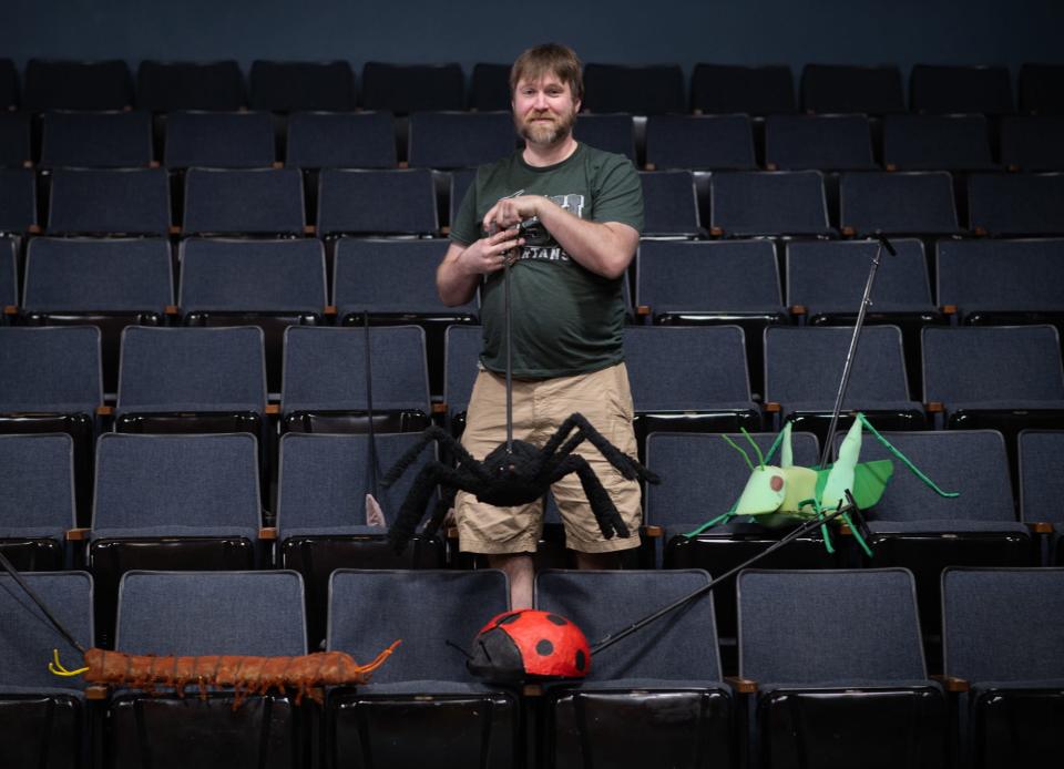 Puppet maker Adam Carlson poses for a portrait, Wednesday, May 15, 2024, with the puppets he created for Riverwalk Theatre's upcoming 'James and the Giant Peach.'
