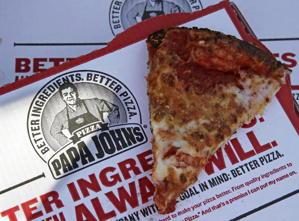 FILE- This Dec. 21, 2017, file photo shows a slice of cheese pizza at the Papa John's pizza shop in Quincy, Mass. Papa John’s plans to pull Schnatter’s image from marketing materials after reports he used a racial slur. Schnatter apologized Wednesday, July 11, and said he would resign as chairman after Forbes reported that he used the slur during a media training session. Schnatter had stepped down as CEO last year after criticizing NFL protests. (AP Photo/Charles Krupa, File)