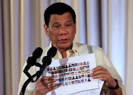 Philippine President Rodrigo Duterte shows to newly promoted officials of the Philippine National Police (PNP) the 'Narco list', which names people involved in the illegal drug trade, during a speech at the Malacanang presidential palace in metro Manila, Philippines January 19, 2017. REUTERS/Romeo Ranoco