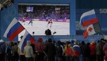 Spectators watch Russia play Finland on screens in the medals plaza during the men's quarter-final ice hockey game at the 2014 Sochi Winter Olympic Games, February 19, 2014. REUTERS/Gary Hershorn