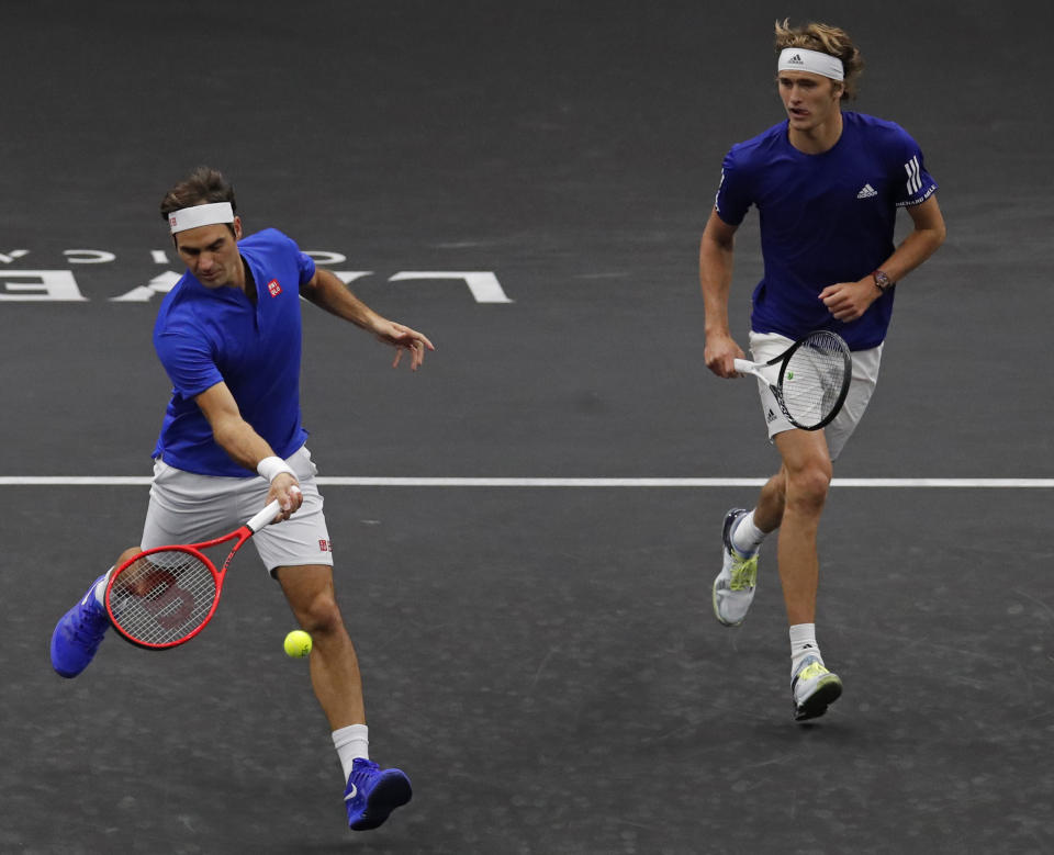 Team Europe's Roger Federer, left, and Alexander Zverev play Team World's John Isner and Jack Sock during a men's doubles tennis match at the Laver Cup, Sunday, Sept. 23, 2018, in Chicago. (AP Photo/Jim Young)