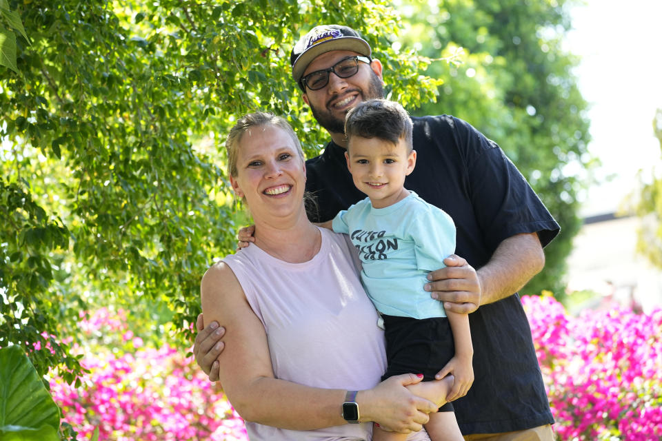 Alicia Celaya, David Cardenas and their son Adrian, 3, are shown at their home, Thursday, April 27, 2023, in Phoenix. Celaya and her family will lose their medicaid coverage later this year, a result of a year-long nationwide review of the 84 million Medicaid enrollees that will require states to remove people whose incomes are now too high for the program. Advocacy groups say beneficiaries are finding the process confusing and at times riddled with errors, leaving some of the country's poorest people suddenly without health insurance and unable to pay for necessary medical care. (AP Photo/Matt York)