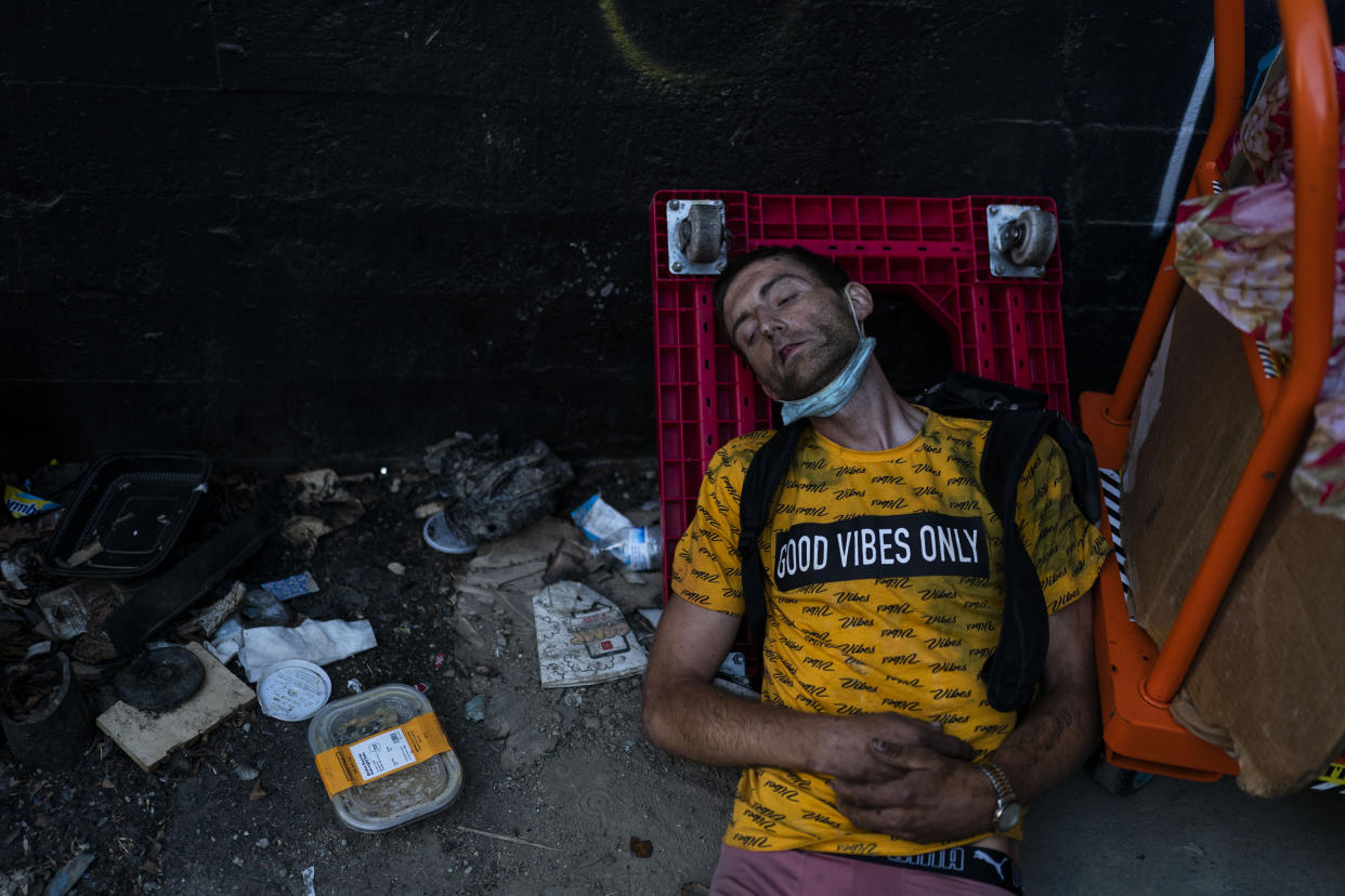 Ryan Smith, a 36-year-old homeless addict, falls asleep after smoking fentanyl in Los Angeles, Thursday, Aug. 18, 2022. Nearly 2,000 homeless people died in the city from April 2020 to March 2021, a 56% increase from the previous year, according to a report released by the Los Angeles County Department of Public Health. Overdose was the leading cause of death, killing more than 700. (AP Photo/Jae C. Hong)