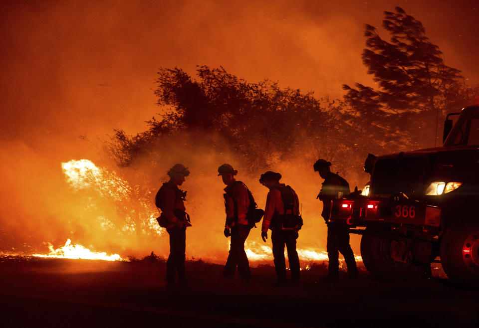 Firefighters monitor the Bear Fire burning in Oroville, Calif., on Wednesday, Sept. 9, 2020. The blaze, part of the lightning-sparked North Complex, expanded at a critical rate of spread as winds buffeted the region. / Credit: Noah Berger / AP