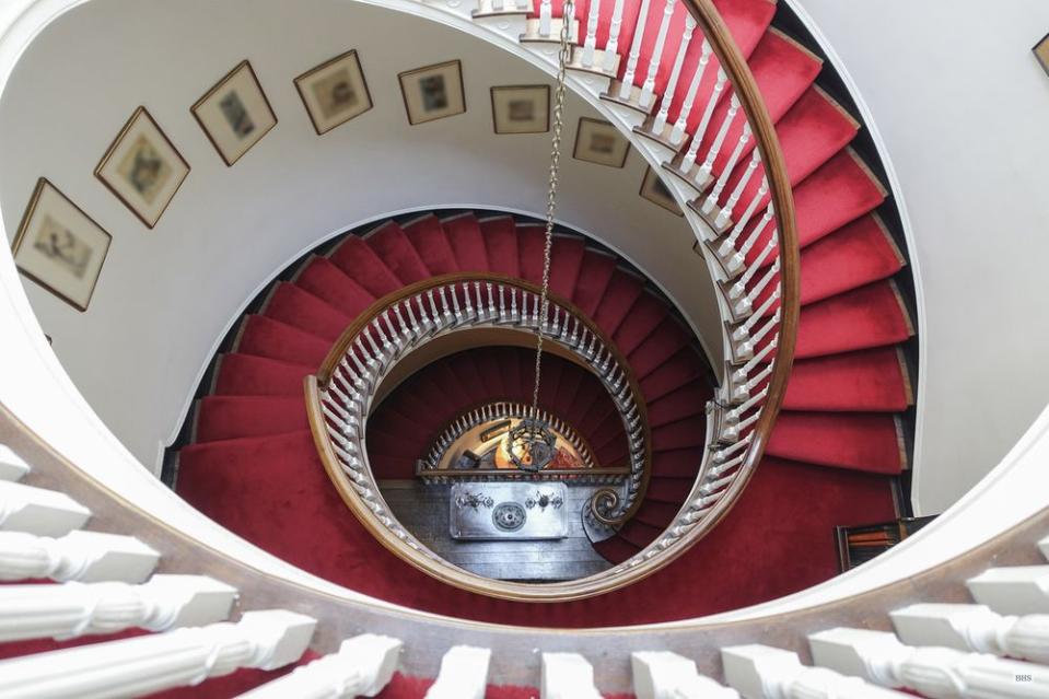 A domed skylight at the top of the spiral staircase fills the interior with sunlight.