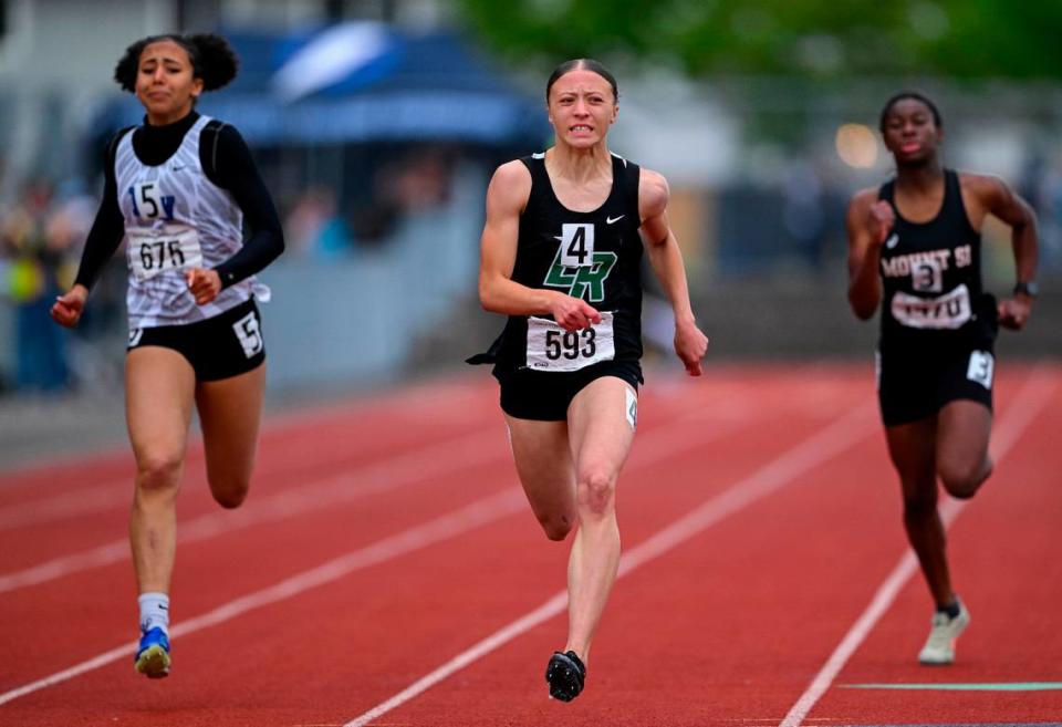 Emerald Ridge’s Mikayla Gardley leads Federal Way’s Casssandra Atkins, left, and Mt. Si’s Beliya Tidd in the 4A girls 200m dash during day 3 of the Track and Field Championship at Mount Tahoma High School, on Saturday, May 25, 2024, in Tacoma, Wash.